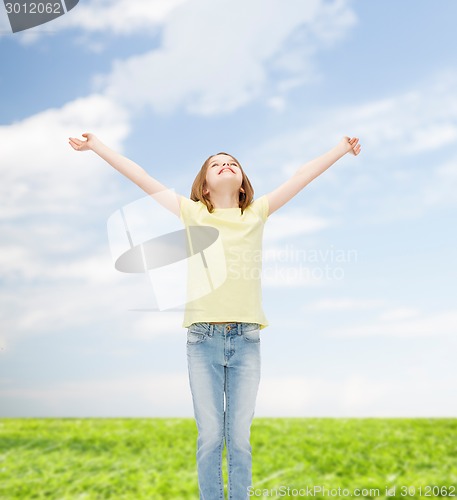 Image of smiling teenage girl with raised hands