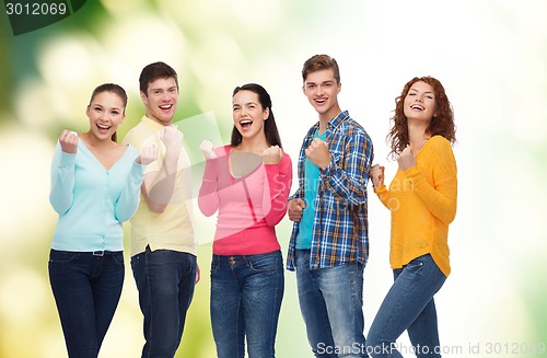 Image of group of smiling teenagers over green background