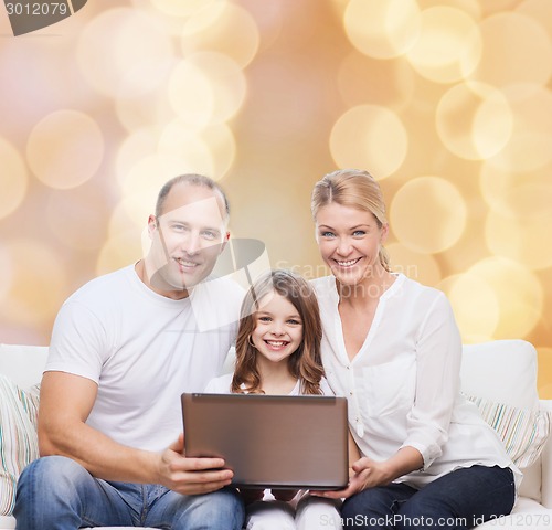 Image of smiling family with laptop