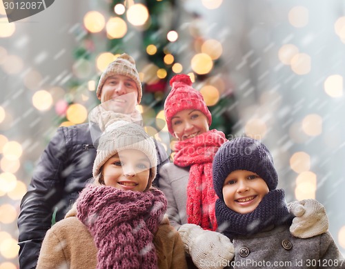 Image of happy family in winter clothes outdoors