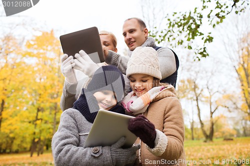 Image of happy family with tablet pc in autumn park