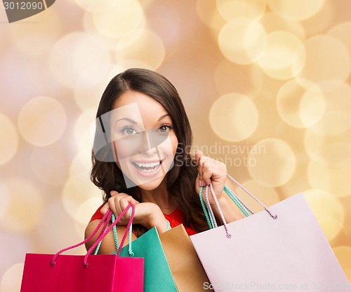 Image of smiling woman with colorful shopping bags