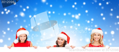 Image of women in santa helper hat with blank white board