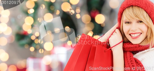 Image of smiling young woman with shopping bags