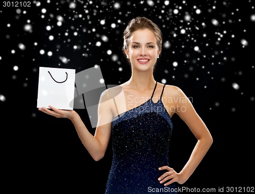 Image of smiling woman with white blank shopping bag