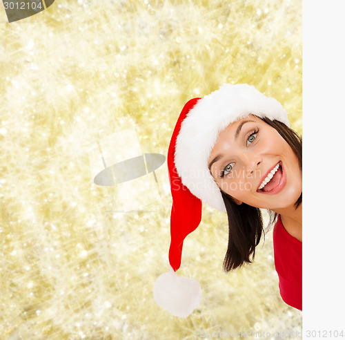 Image of woman in santa helper hat with blank white board
