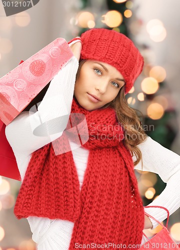 Image of smiling young woman with shopping bags