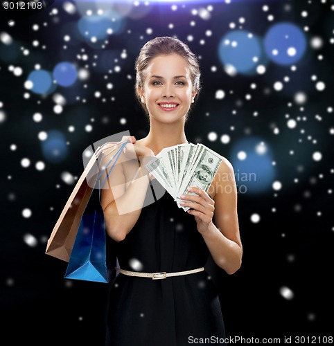 Image of smiling woman in dress with shopping bags