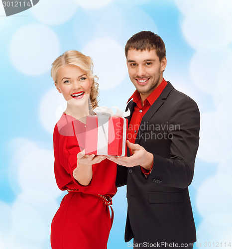 Image of smiling man and woman with present