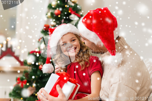 Image of smiling father and daughter holding gift box