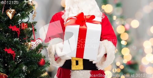 Image of man in costume of santa claus with gift box