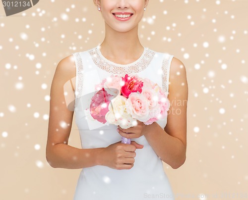 Image of close up of woman in white dress with flowers