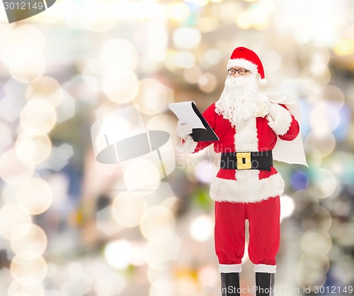 Image of man in costume of santa claus with notepad and bag