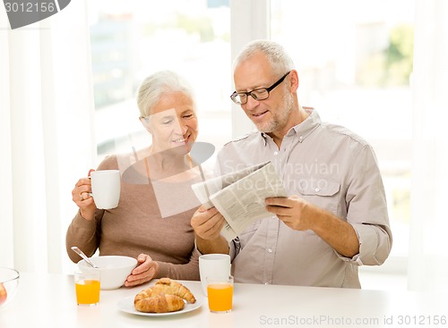 Image of happy senior couple having breakfast at home