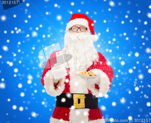 Image of santa claus with glass of milk and cookies
