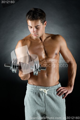 Image of young man with dumbbell