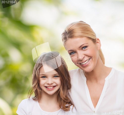 Image of smiling mother and little girl