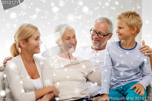 Image of happy family sitting on couch at home