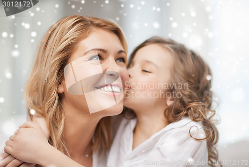 Image of happy mother with daughter hugging and kissing