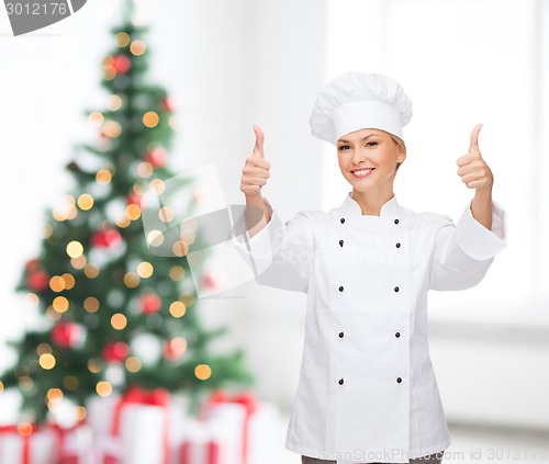 Image of smiling female chef showing thumbs up