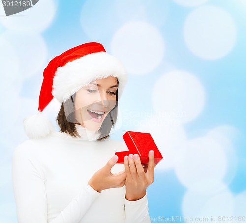 Image of smiling woman in santa helper hat with gift box