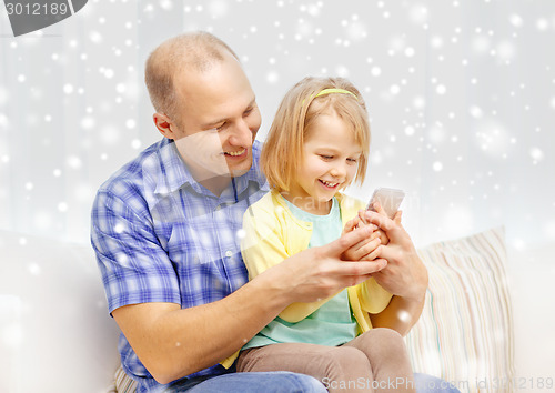 Image of happy father and daughter with smartphone