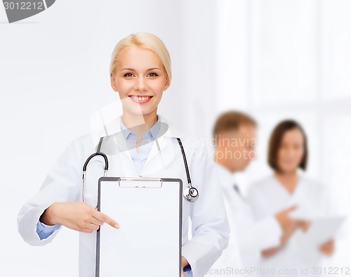 Image of smiling female doctor with clipboard