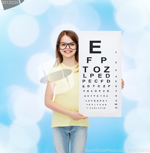 Image of little girl in eyeglasses with eye checking chart