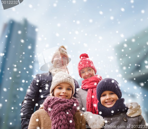 Image of happy family in winter clothes outdoors