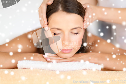 Image of beautiful woman getting face or head massage