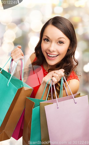 Image of smiling woman with colorful shopping bags