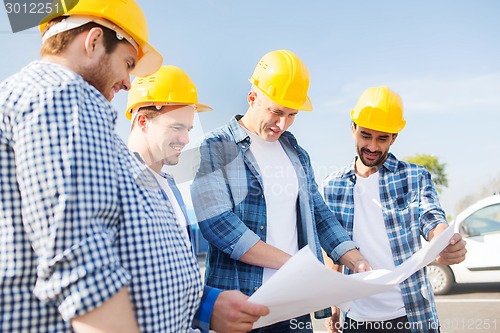 Image of group of builders with tablet pc and blueprint