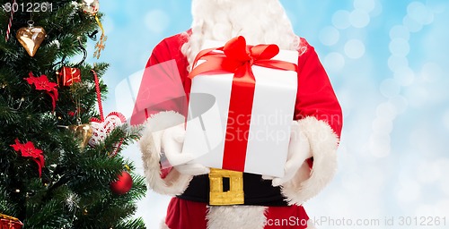 Image of man in costume of santa claus with gift box