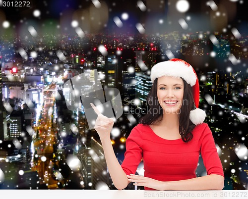 Image of smiling woman in santa helper hat