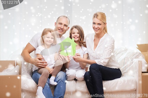 Image of smiling parents and two little girls at new home