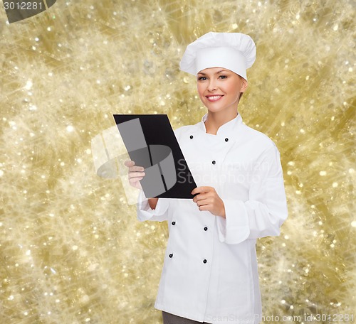 Image of smiling female chef with black blank paper