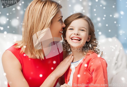 Image of happy mother and girl whispering into ear