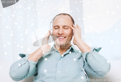 Image of smiling man in headphones listening to music