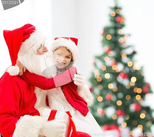 Image of smiling little girl with santa claus