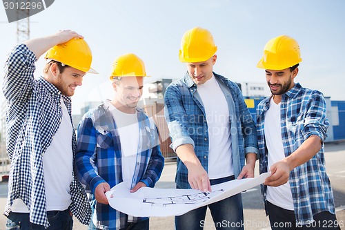 Image of group of builders with tablet pc and blueprint