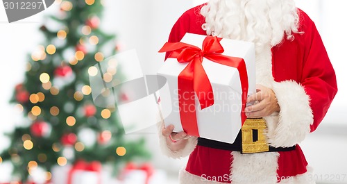 Image of man in costume of santa claus with gift box