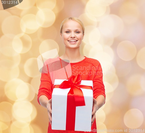 Image of smiling woman in red clothes with gift box