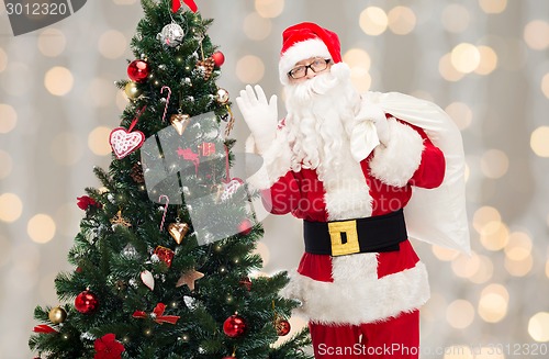 Image of santa claus with bag and christmas tree