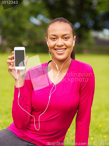Image of smiling african american woman with smartphone