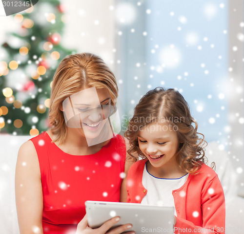 Image of mother and daughter with tablet pc at home