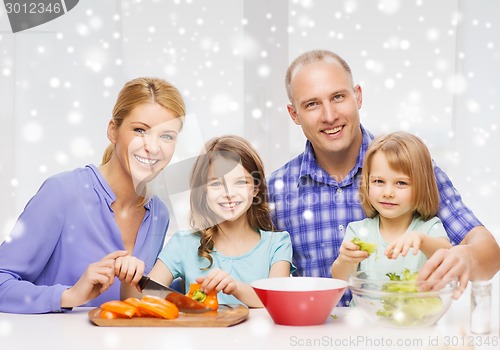 Image of happy family with two kids making dinner at home