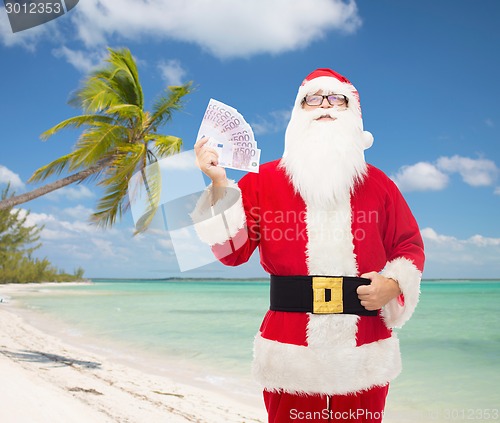 Image of man in costume of santa claus with euro money