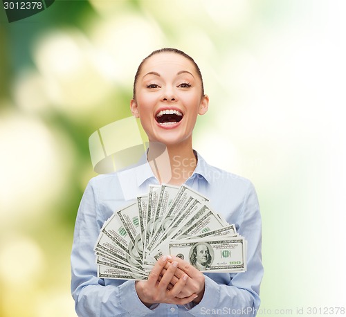 Image of laughing businesswoman with dollar cash money