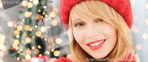 Image of close up of smiling young woman in winter clothes