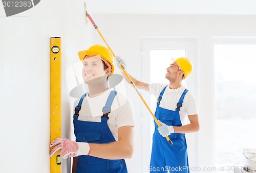 Image of group of builders with tools indoors